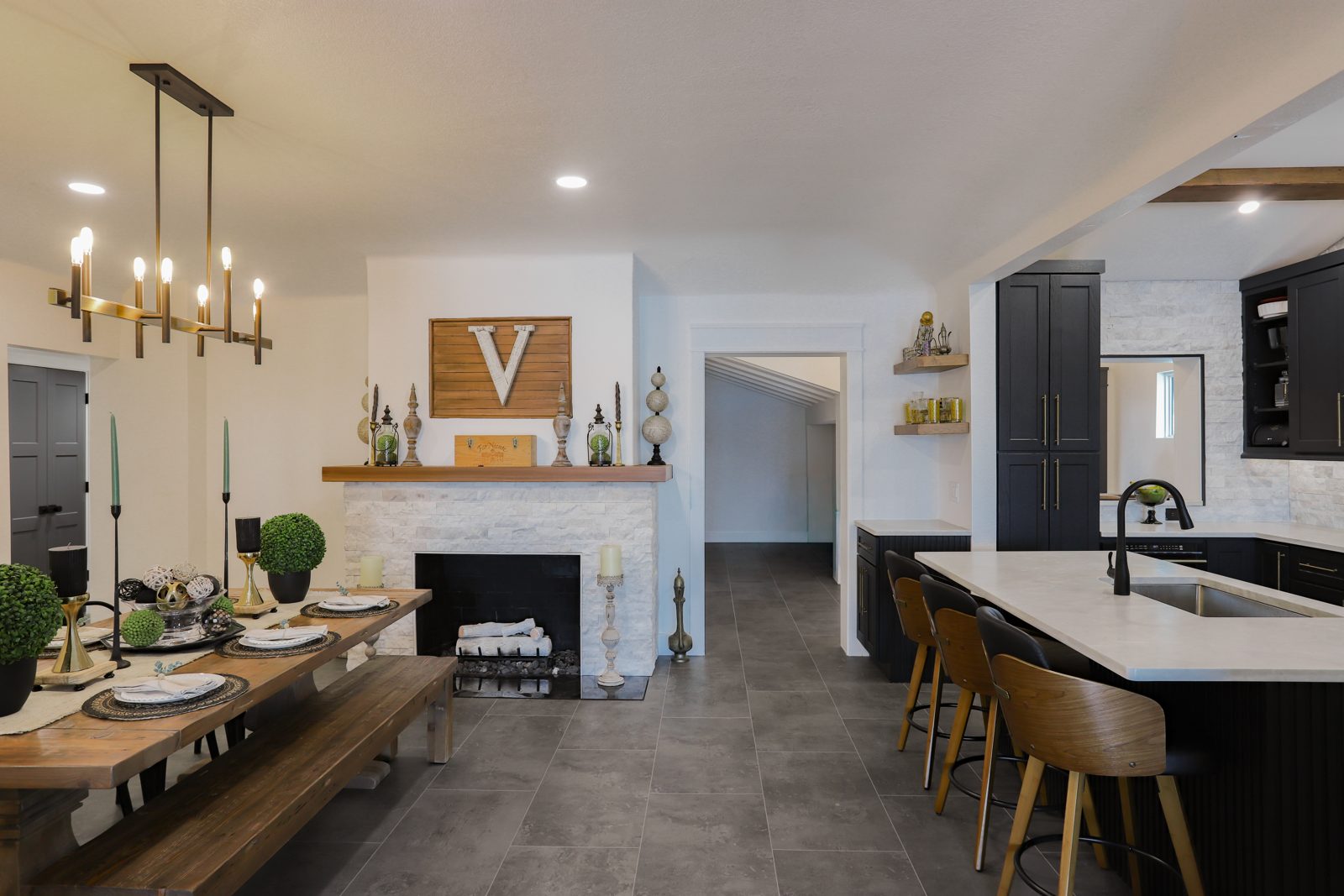 Luxury open-concept dining room, fireplace and kitchen in a custom Madeira Beach coastal home remodel